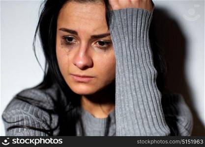 people, grief and domestic violence concept - close up of unhappy crying woman. close up of unhappy crying woman