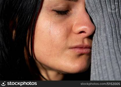 people, grief and domestic violence concept - close up of unhappy crying woman. close up of unhappy crying woman