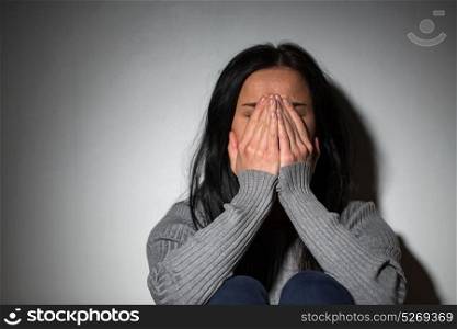 people, grief and domestic violence concept - unhappy crying woman. sad crying woman suffering from domestic violence