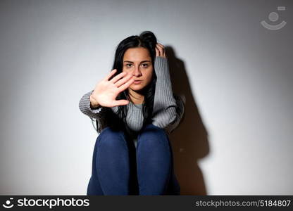 people, grief and domestic violence concept - unhappy woman sitting on floor and crying at home. unhappy woman crying on floor at home