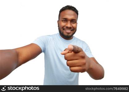 people, grooming and beauty concept - portrait of happy smiling young african american man taking selfie over white background. smiling young african american man taking selfie
