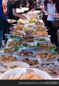 people group catering buffet food indoor in school restaurant with meat colorful fruits and vegetables