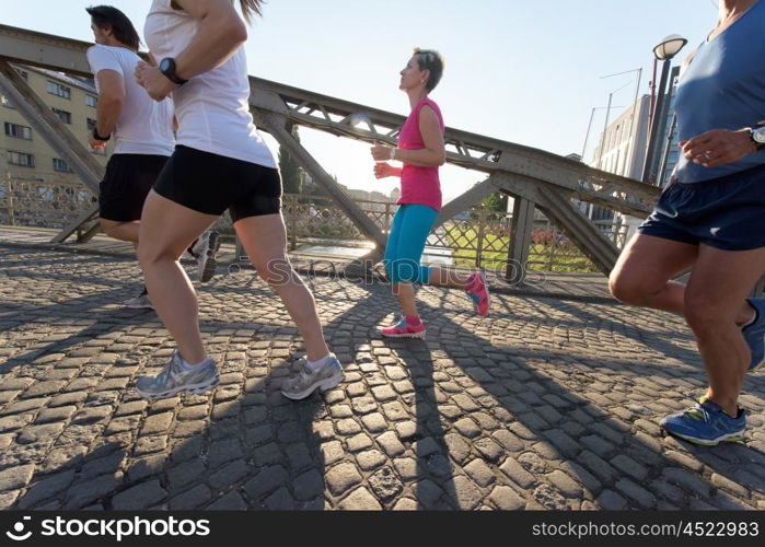 people group jogging runners team on morning training workout with sunrise in background