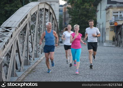 people group jogging runners team on morning training workout with sunrise in background