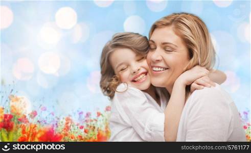 people, happiness, love, family and motherhood concept - happy mother and daughter hugging over blue lights and poppy field background