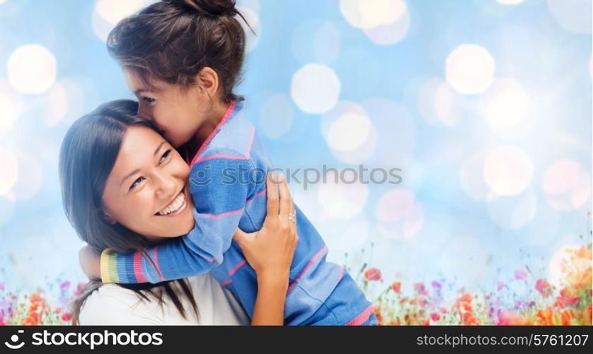 people, happiness, love, family and motherhood concept - happy mother and daughter hugging over blue lights and poppy field background