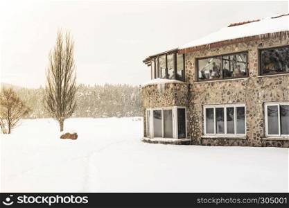 People have a rest at cafe .Winter landscape view with pine forest at a cloudy dull day.29 January,2016. People have a rest at cafe .Winter landscape view