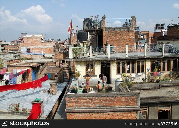 People have bath on the roof of building in Patan, Nepal