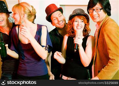 People having a karaoke party, presumably in a club or a similar location