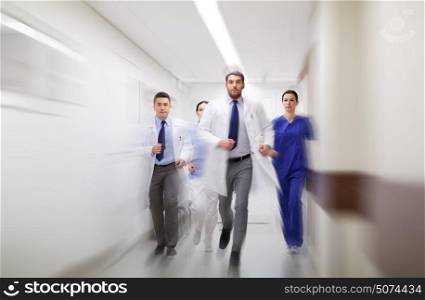 people, health care and medicine concept - group of medics running along hospital (motion blur effect). group of medics walking along hospital