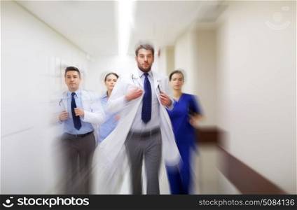people, health care and medicine concept - group of medics running along hospital (motion blur effect). group of medics walking along hospital. group of medics walking along hospital