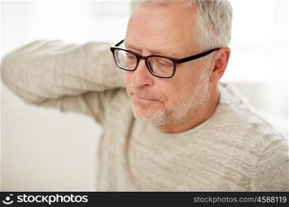 people, health, old age and problem concept - close up of unhappy senior man suffering from neck ache
