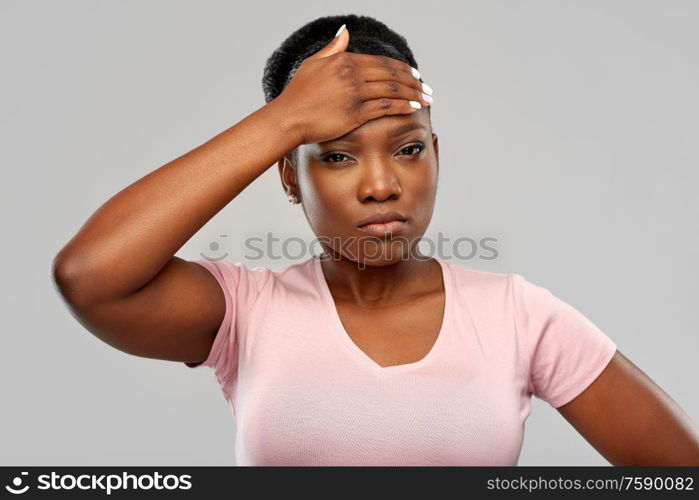 people, health problem and stress concept - unhappy african american woman suffering from headache or fever over grey background. african american woman having headache or fever