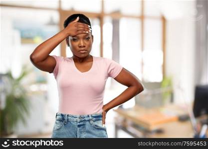 people, health problem and stress concept - unhappy african american woman suffering from headache or fever over office background. african american woman having headache or fever