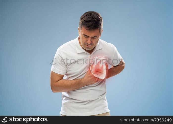 people, healthcare and health problem concept - unhappy middle-aged man having heart attack or heartache over blue background. unhappy man having heart attack or heartache