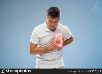 people, healthcare and health problem concept - unhappy middle-aged man having heart attack or heartache over blue background. unhappy man having heart attack or heartache