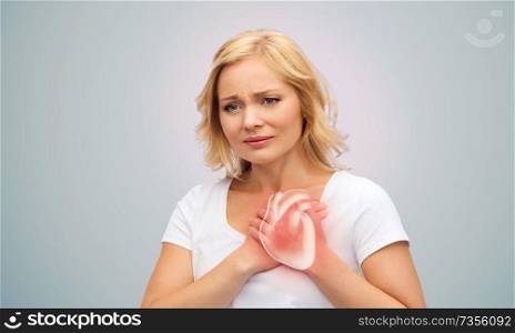 people, healthcare and health problem concept - unhappy middle-aged woman having heart attack or heartache over grey background. unhappy woman having heart attack or heartache