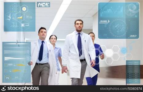 people, healthcare and medicine concept - group of medics walking along hospital. group of medics walking along hospital