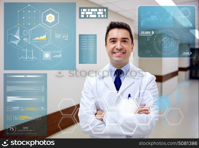 people, healthcare and medicine concept - smiling doctor at hospital corridor. smiling doctor at hospital corridor