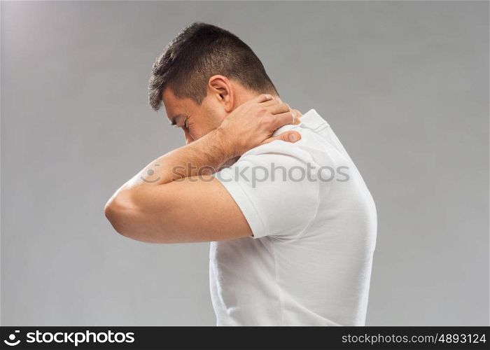 people, healthcare and problem concept - close up of man suffering from neck pain over gray background