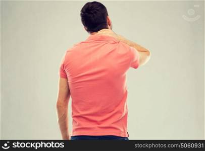 people, healthcare and problem concept - man suffering from neck pain. man suffering from neck pain