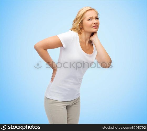 people, healthcare, backache and problem concept - unhappy middle aged woman suffering from pain in back or reins over blue background