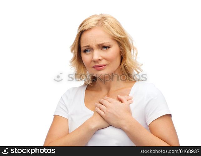 people, healthcare, heart disease and problem concept - unhappy woman suffering from heartache