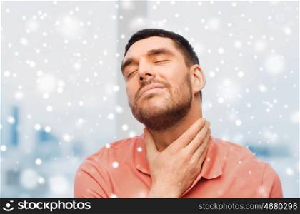 people, healthcare, winter, christmas and problem concept - unhappy man touching her neck and suffering from throat pain over snow