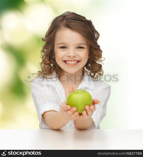 people, healthy food, children and happiness concept - happy girl with green apple over green background
