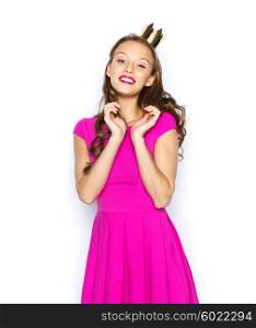people, holidays and fashion concept - happy young woman or teen girl in pink dress and princess crown