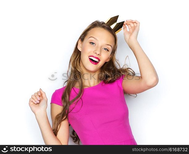 people, holidays and fashion concept - happy young woman or teen girl in pink dress and princess crown