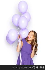 people, holidays and fashion concept - happy young woman or teen girl in ultra violet dress with helium air balloons. happy girl in ultra violet dress with balloons