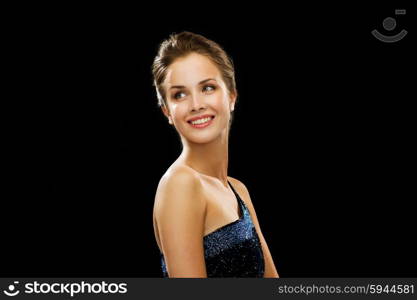 people, holidays and glamour concept - beautiful woman wearing dress and pearl earrings over black background