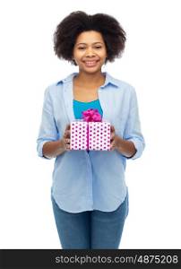 people, holidays and greeting concept - happy african american young woman with birthday gift box over white