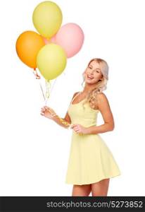 people, holidays and summer party concept - happy young woman or teen girl in pink dress with helium air balloons. happy woman in dress with helium air balloons