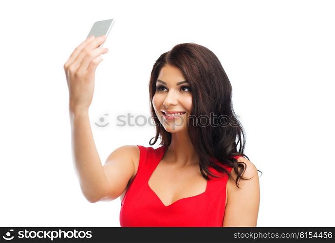 people, holidays and technology concept - beautiful sexy woman in red dress taking selfie picture by smartphone