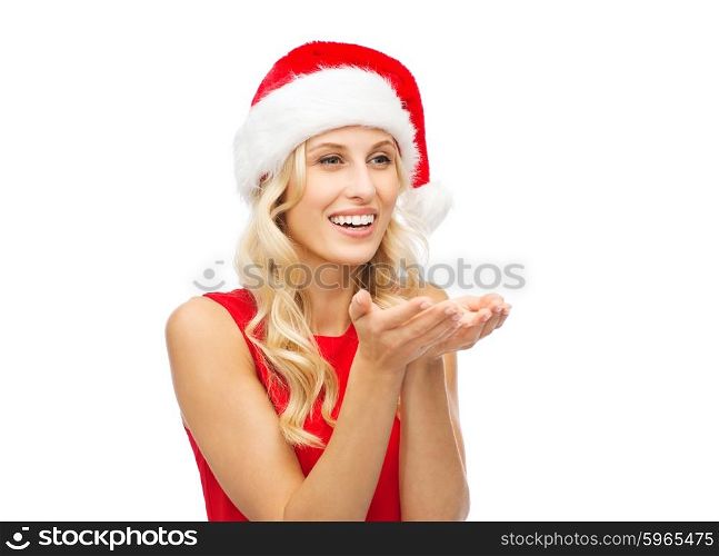 people, holidays, christmas and advertisement concept - happy blonde woman in santa hat holding something on empty palms