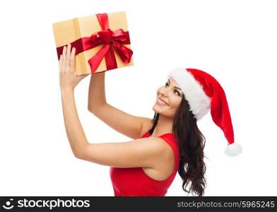 people, holidays, christmas and celebration concept - beautiful sexy woman in red dress and santa hat with gift box