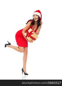 people, holidays, christmas and celebration concept - beautiful sexy woman in red dress and santa hat with gift box listening to something