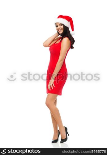 people, holidays, christmas and celebration concept - beautiful sexy woman in santa hat and red dress posing full-length
