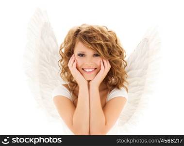 people, holidays, christmas and religious concept - happy young woman or teen girl with angel wings over white background