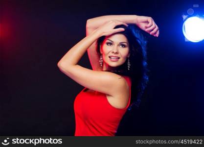 people, holidays, disco, night lifestyle and leisure concept - beautiful sexy woman in red dress dancing at nightclub