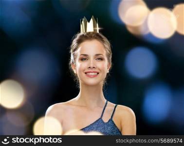people, holidays, royalty, celebration and glamour concept - smiling woman in evening dress wearing golden crown over black background over night lights background