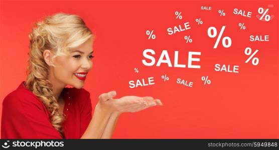 people, holidays, sale, shopping and advertisement concept - lovely woman in red clothes holding something on palms of her hands over red background with sale and percentage signs