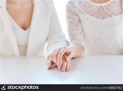 people, homosexuality, same-sex marriage and love concept - close up of happy married lesbian couple hands