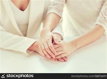 people, homosexuality, same-sex marriage and love concept - close up of happy married lesbian couple hands