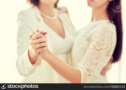 people, homosexuality, same-sex marriage and love concept - close up of happy married lesbian couple dancing