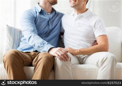 people, homosexuality, same-sex marriage, attraction and love concept - close up of happy male gay couple hugging at home
