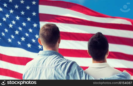 people, homosexuality, same-sex marriage, gay and love concept - close up of happy male gay couple or friends hugging from back over american flag background