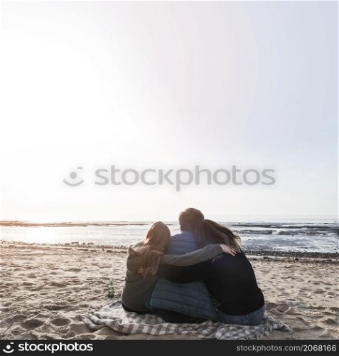 people hugging looking sea